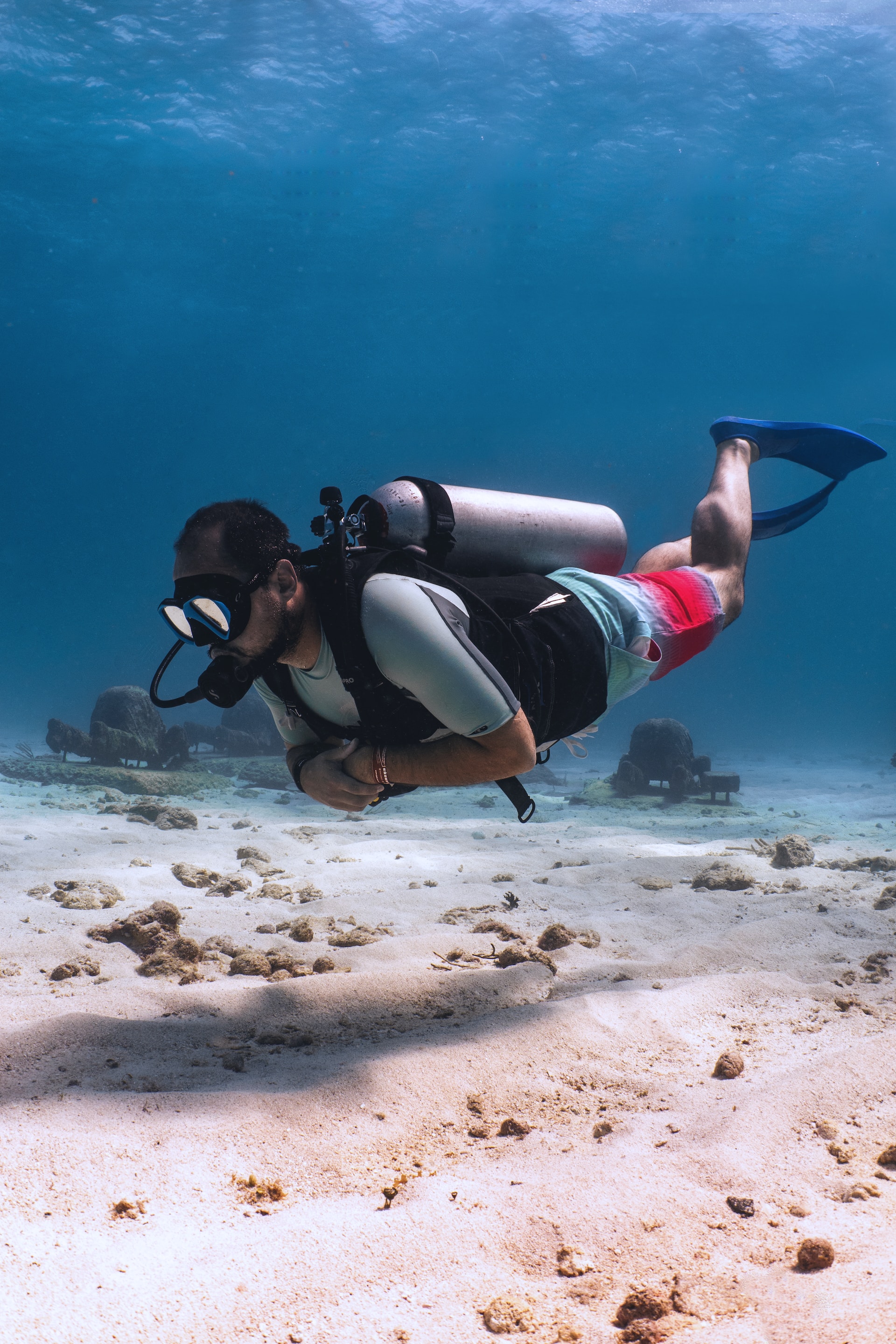 Man scuba diving floating near bottom