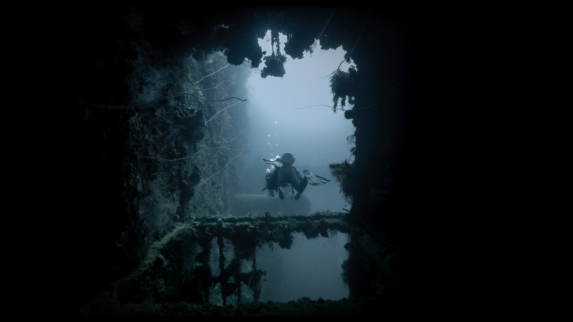 Dark wreck with scuba diver